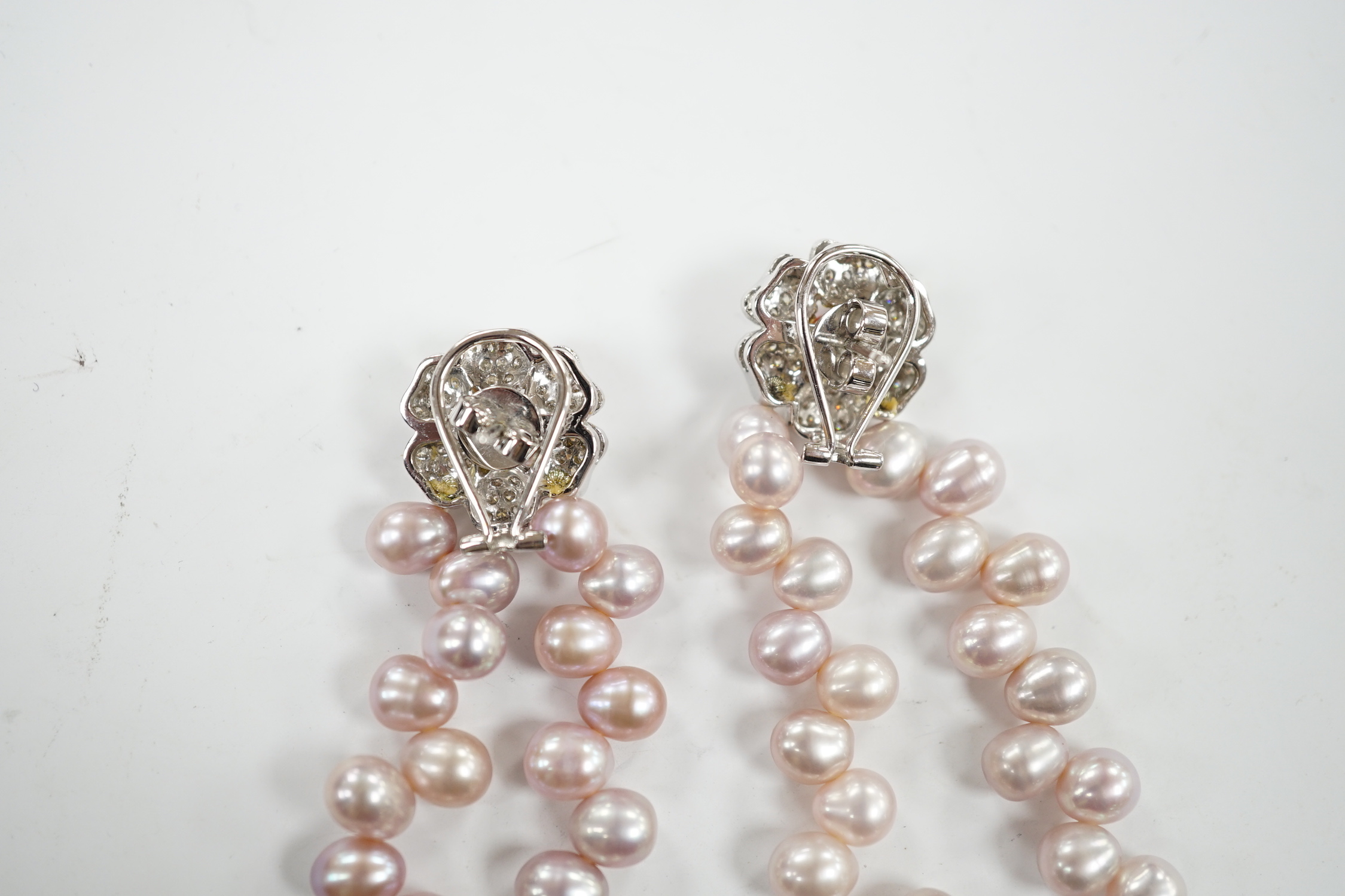 A modern pair of white metal, diamond chip cluster and three row pink cultured pearl tassel drop earrings, 91mm.